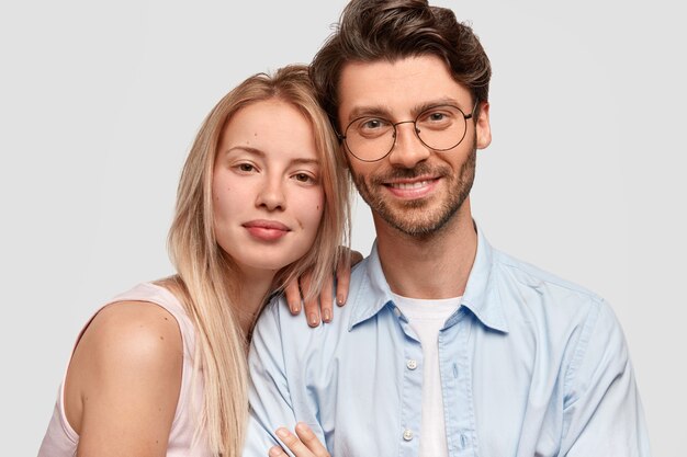 Man and woman in casual clothes posing