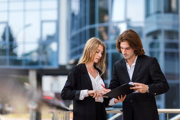 Man and woman checking a clipboard