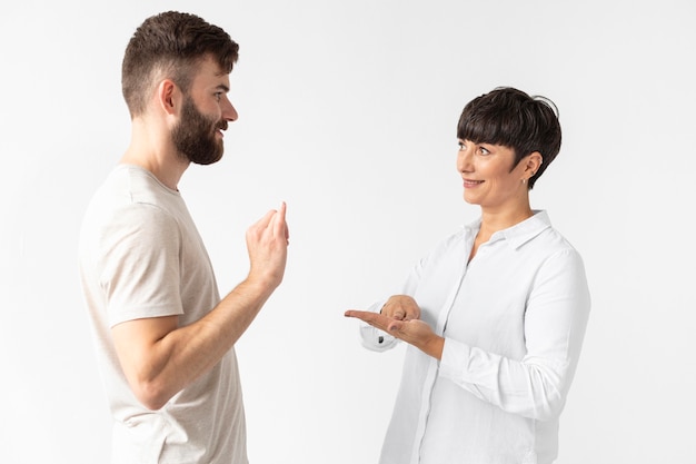 Free photo man and woman communicating through sign language