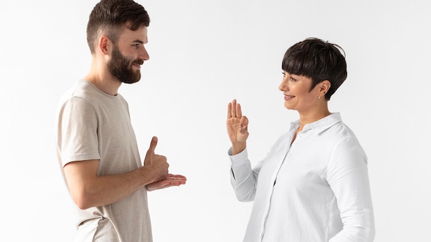 Free photo man and woman communicating through sign language