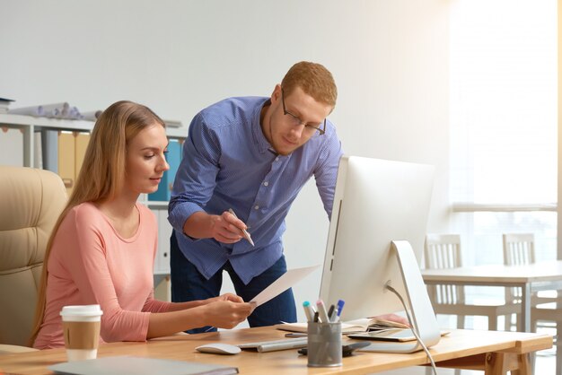 Man and woman coworking on business document generating ideas