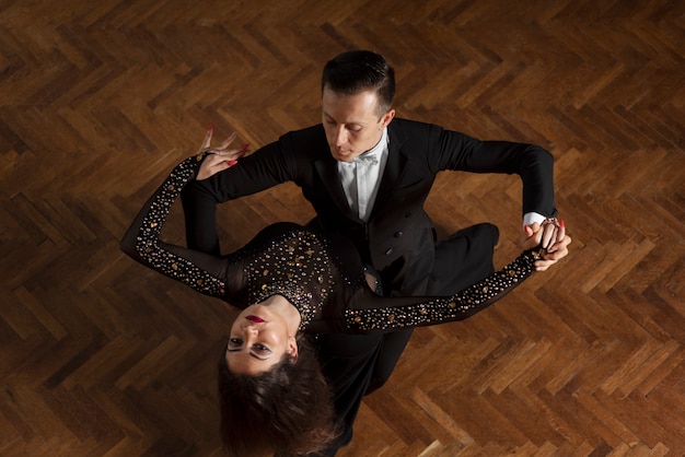 Man and woman dancing together in a ballroom scene