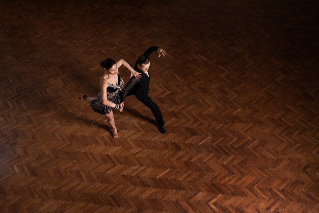 Man and woman dancing together in a ballroom scene