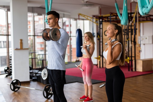 Free photo man and woman doing weight training