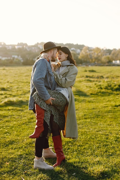 Free photo man and woman in fashion clothes resting on a nature together