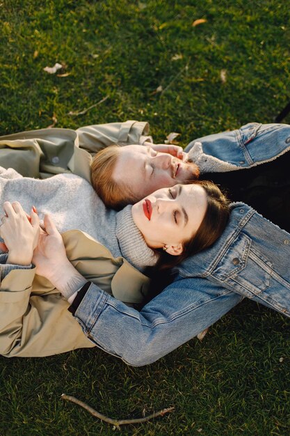 Man and woman in fashion clothes resting on a nature together