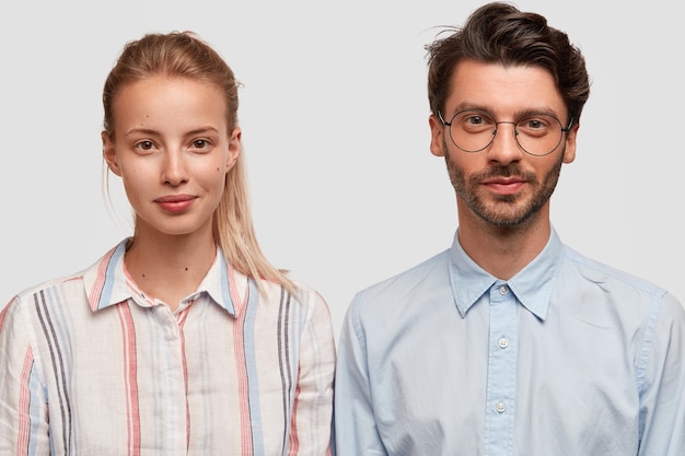 Man and woman in formal clothes posing