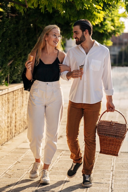 Man and woman going to the park to have a picnic