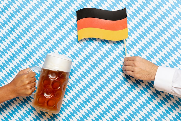 Free photo man and woman holding beer pint and flag