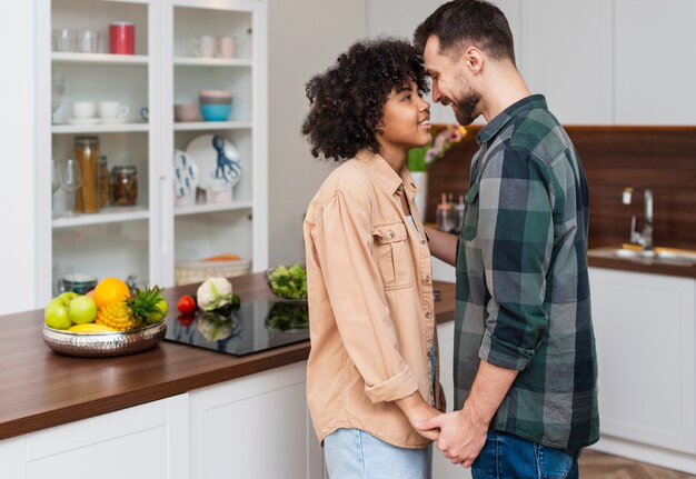 Man and woman holding hands and looking at each other