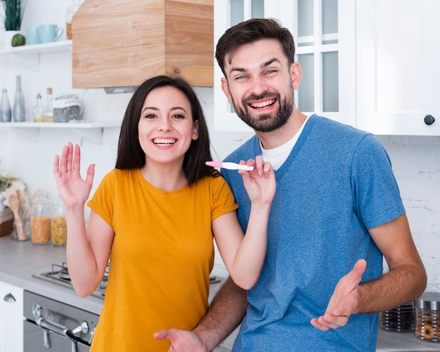 Man and woman holding pregnancy test