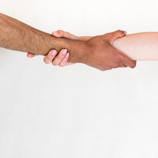 Free photo man and woman holding their hands isolated over white background