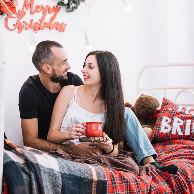 Man and woman hugging on bed 