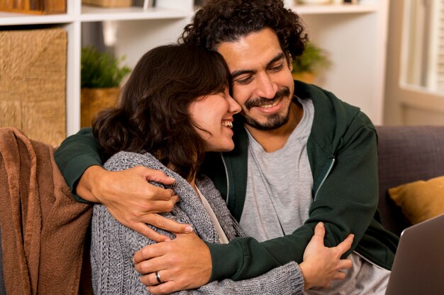 Man and woman hugging on the sofa