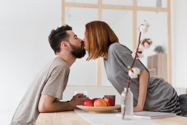 Man and woman kissing in the kitchen