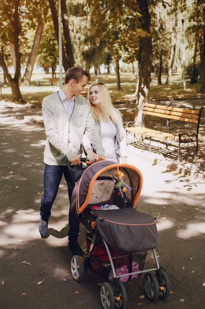 Man and woman looking at each other while walking their baby