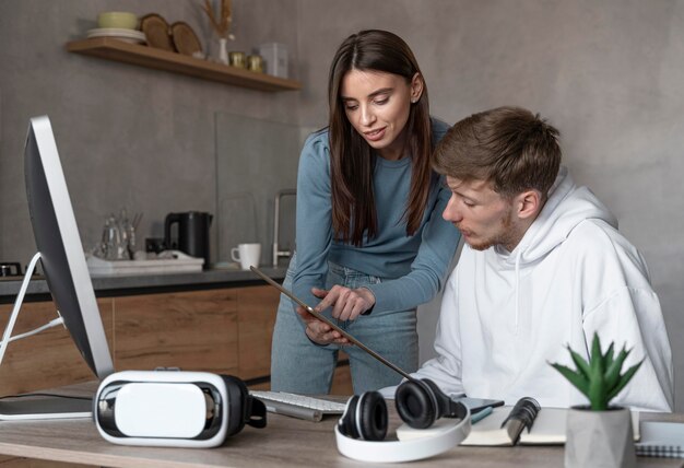 Man and woman looking at tablet together at work