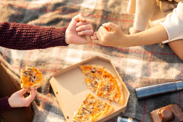 Man and woman making a pinky swear