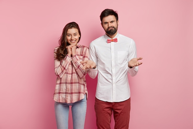 Man and woman posing in colorful clothes