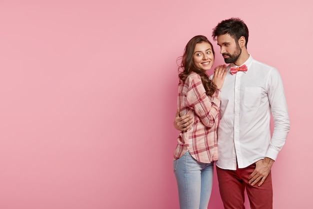 Man and woman posing in colorful clothes