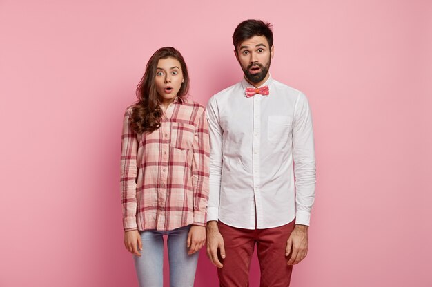 Man and woman posing in colorful clothes