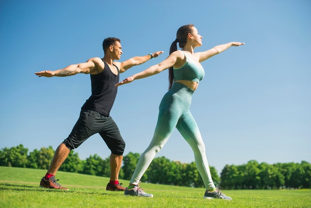 Man and woman practicing yoga outdoor