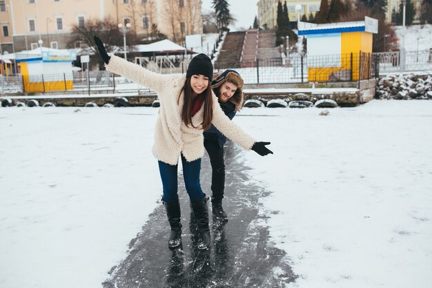 Man and woman riding on the ice on a frozen lake