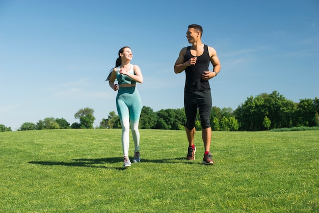 Man and woman running outdoor in a park