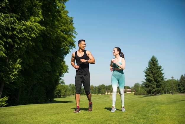 Man and woman running outdoor in a park