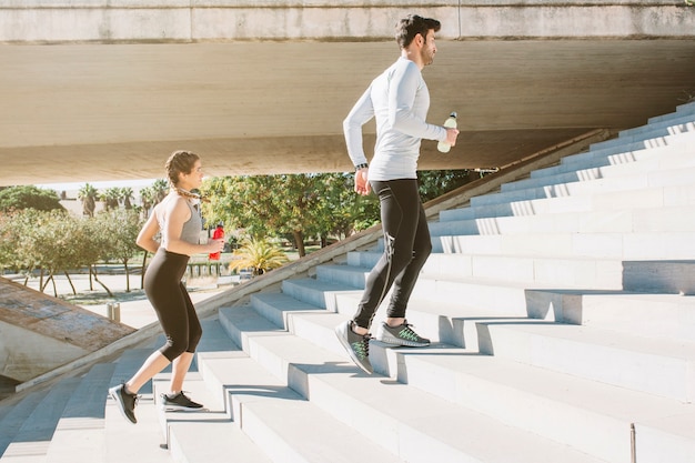 Man and woman running steps working out