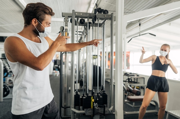 Free photo man and woman saluting each other at the gym