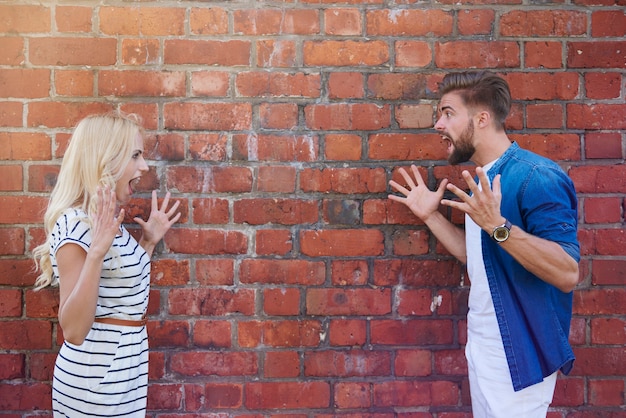 Man and woman screaming on each other