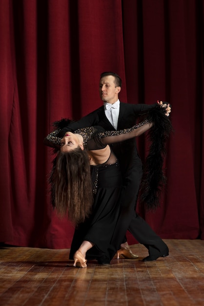 Man and woman showing ballroom dancing together