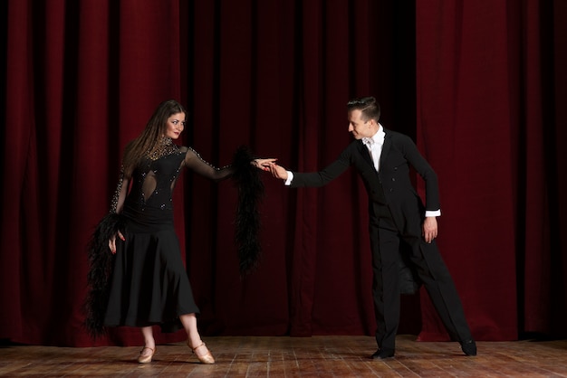 Man and woman showing ballroom dancing together