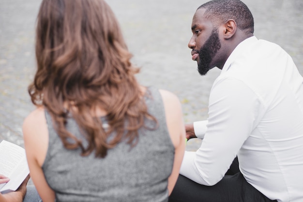 Man and woman sitting outside