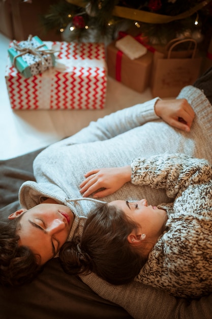 Man and woman sleeping at present boxes 