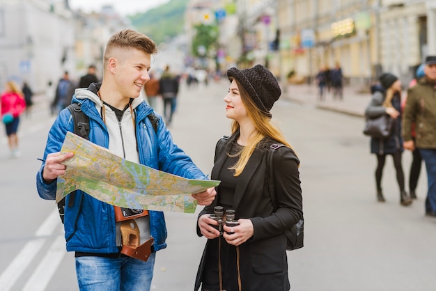 Man and woman smiling with map