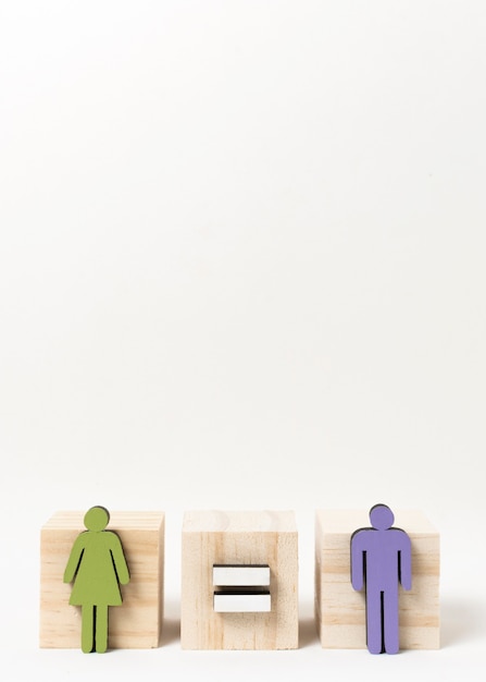 Free photo man and woman standing on wooden blocks copy space