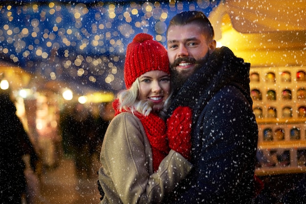 Man and woman surrounded with snowflakes