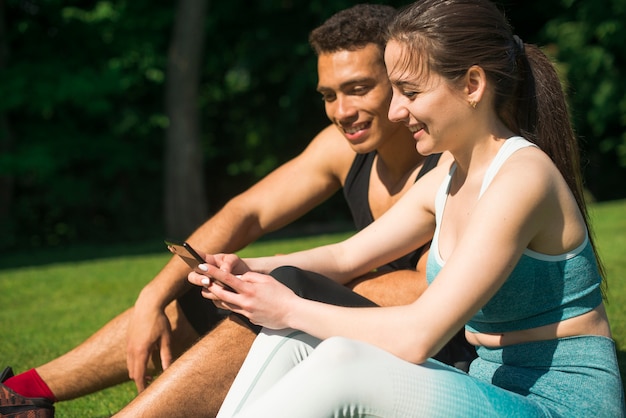 Man and woman taking a selfie in a park