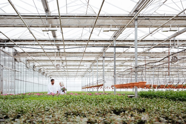 Man and woman talking while working with plants