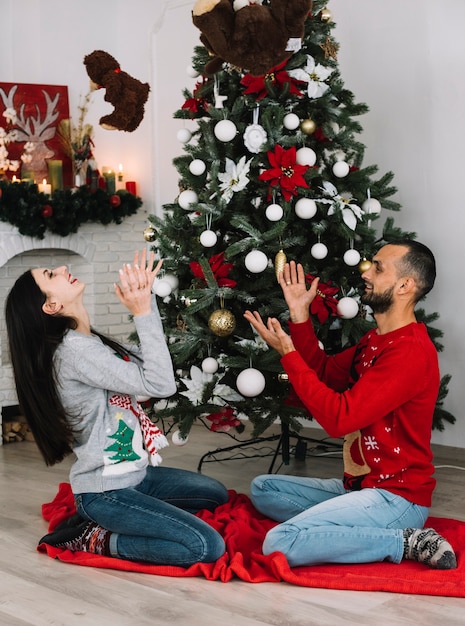 Man and woman throwing up soft toys