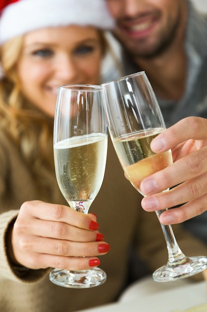 Free photo man and woman toasting with champagne glasses