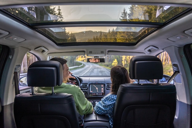 Free photo man and woman traveling in car sitting in car driving to travel destination