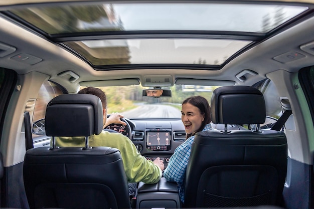 Free photo man and woman traveling in car sitting in car driving to travel destination