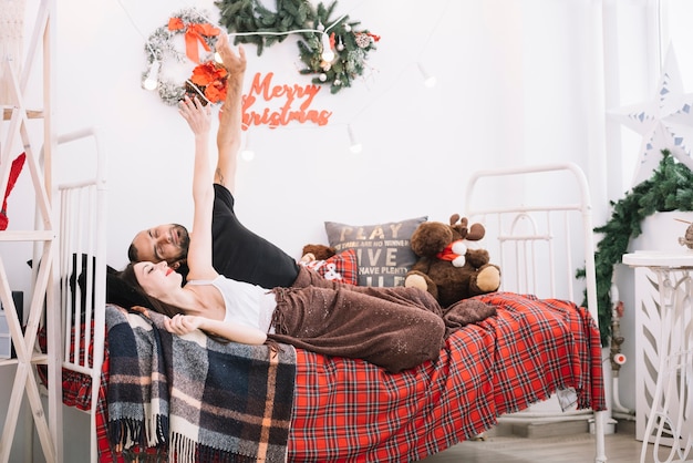 Free Photo man and woman upping hands on bed