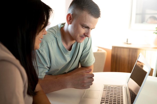 Man and woman using laptop for online shopping