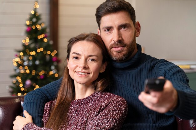 Man and woman watching tv on christmas