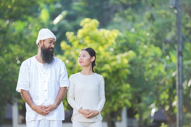 Man and woman in white outfit smiling to each other in happiness emotion