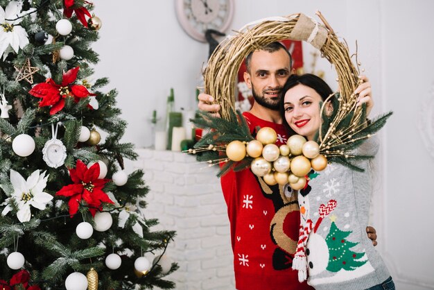 Man and woman with Christmas wreath